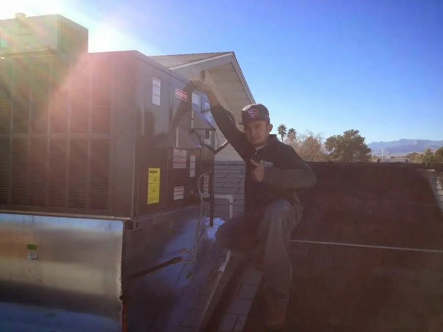 HVAC technician performing HVAC Inspection on a rooftop unit in Bossier City